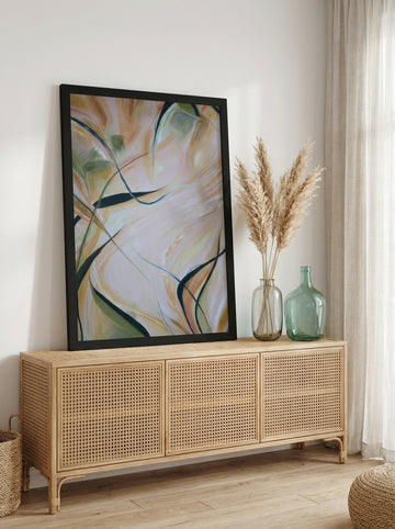 Modern wall art print standing on a sideboard in a coastal living room