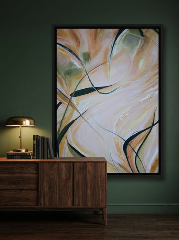 Canvas wall art with a black surround styled on the wall in a moody living room