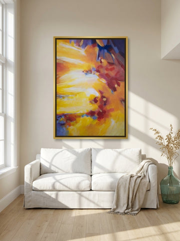 Oversized statement canvas wall art with a gold leaf surround styled on the wall in a coastal living room