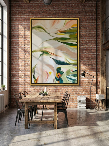 Oversized statement canvas wall art with a gold leaf surround styled on the wall in an industrial loft dining room