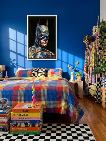 Canvas wall art with a white surround styled on the wall in a colourful eclectic bedroom