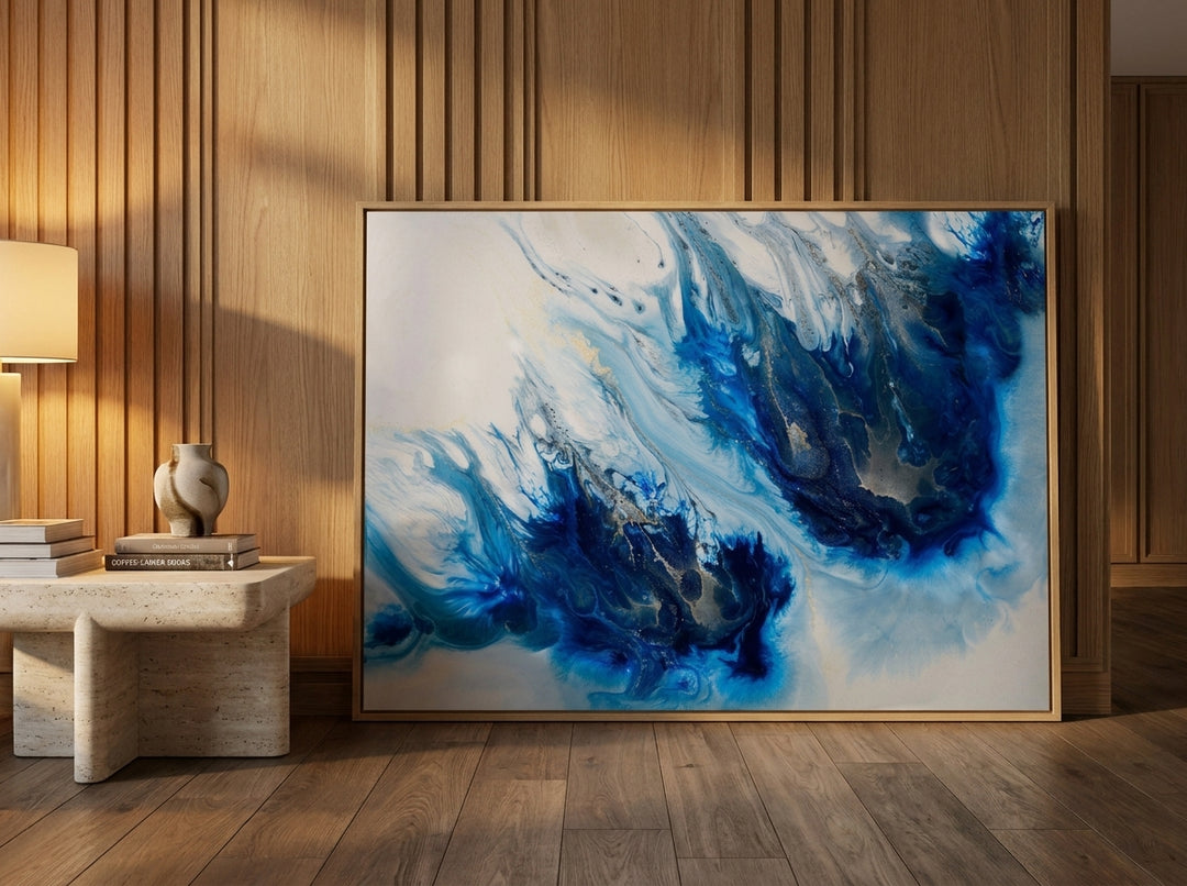 Oversized statement modern wall art print leaning against the wall in a luxe living room