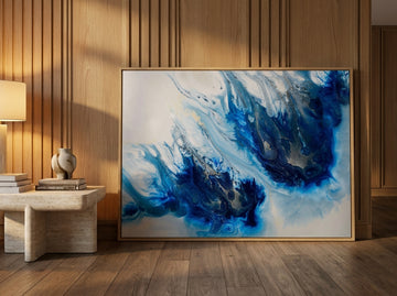 Oversized statement modern wall art print leaning against the wall in a luxe living room
