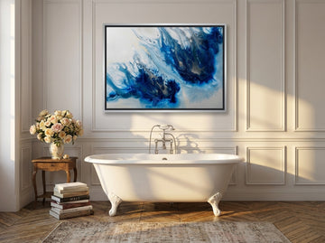 Canvas wall art with a silver leaf surround styled on the wall in a Parisian bathroom