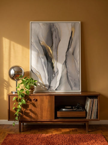 Canvas wall art with a white surround standing on a sideboard in a retro 70s dining room