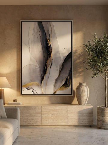 Oversized statement canvas wall art with a silver leaf surround styled on the wall in a luxe living room