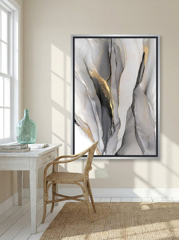 Canvas wall art with a silver leaf surround styled on the wall in a coastal home office