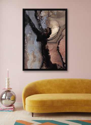 Canvas wall art with a black surround styled on the wall in a colourful eclectic living room