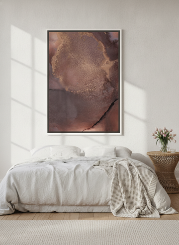 Canvas wall art with a white surround styled on the wall in a bright Scandinavian bedroom