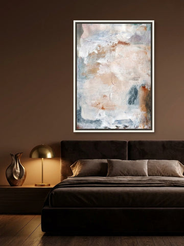 Canvas wall art with a white surround styled on the wall in a moody bedroom