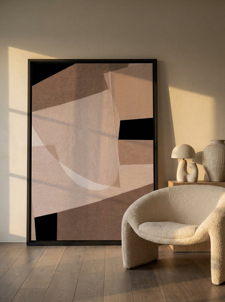 Oversized statement canvas wall art with a black surround leaning against the wall in a luxe living room