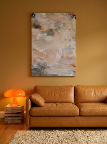 Stretched canvas wall art styled on the wall in a retro 70s living room