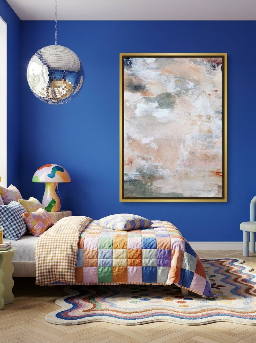 Canvas wall art with a gold leaf surround styled on the wall in a colourful eclectic bedroom