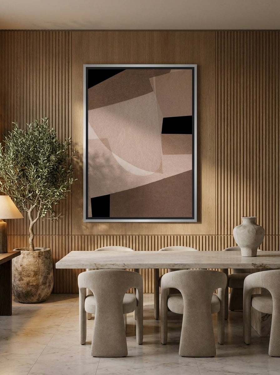 Oversized statement canvas wall art with a silver leaf surround styled on the wall in a luxe dining room