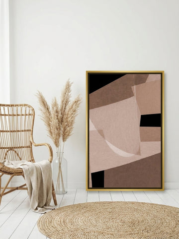 Canvas wall art with a gold leaf surround leaning against the wall in a coastal home office