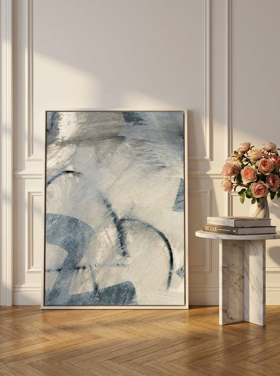 Canvas wall art with a white surround leaning against the wall in a Parisian home office