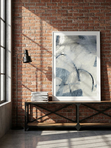 Modern wall art print standing on a console in an industrial loft bedroom