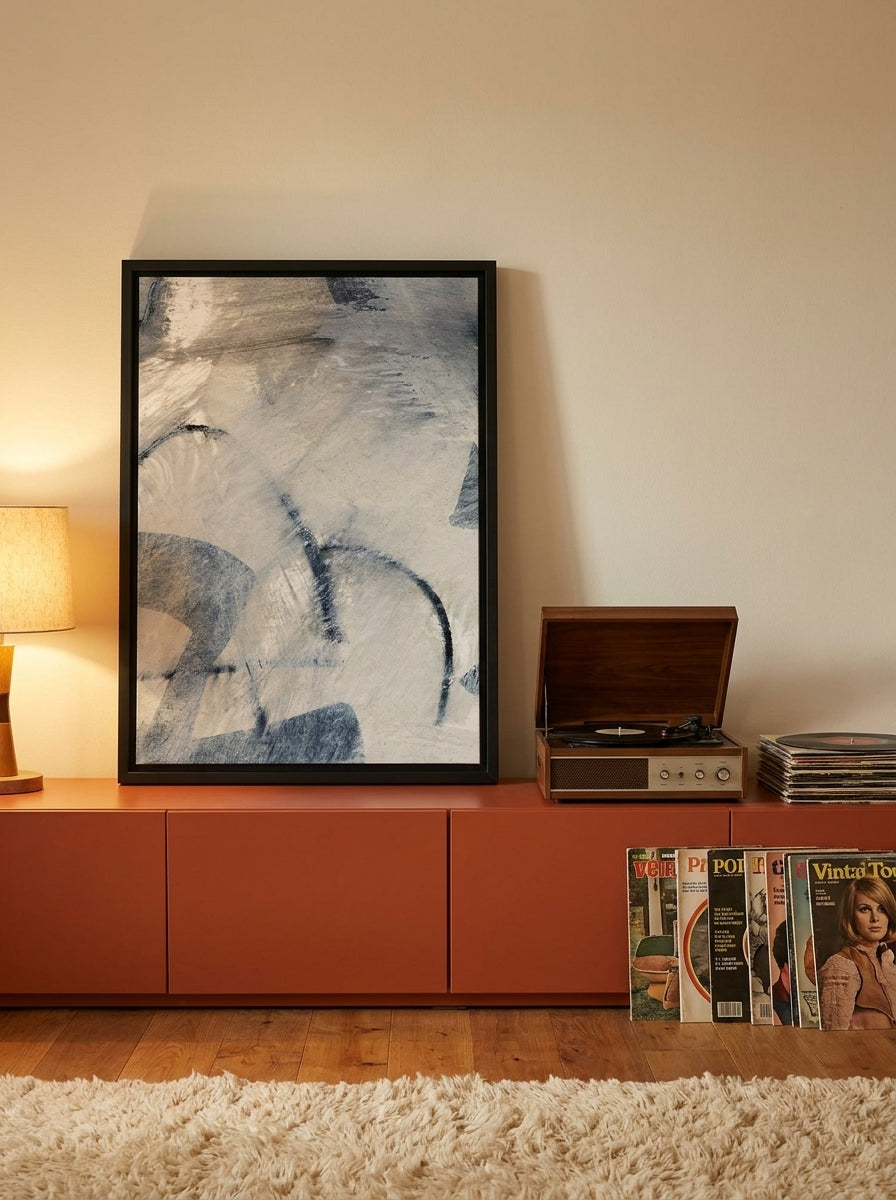 Canvas wall art with a black surround standing on a sideboard in a retro 70s living room