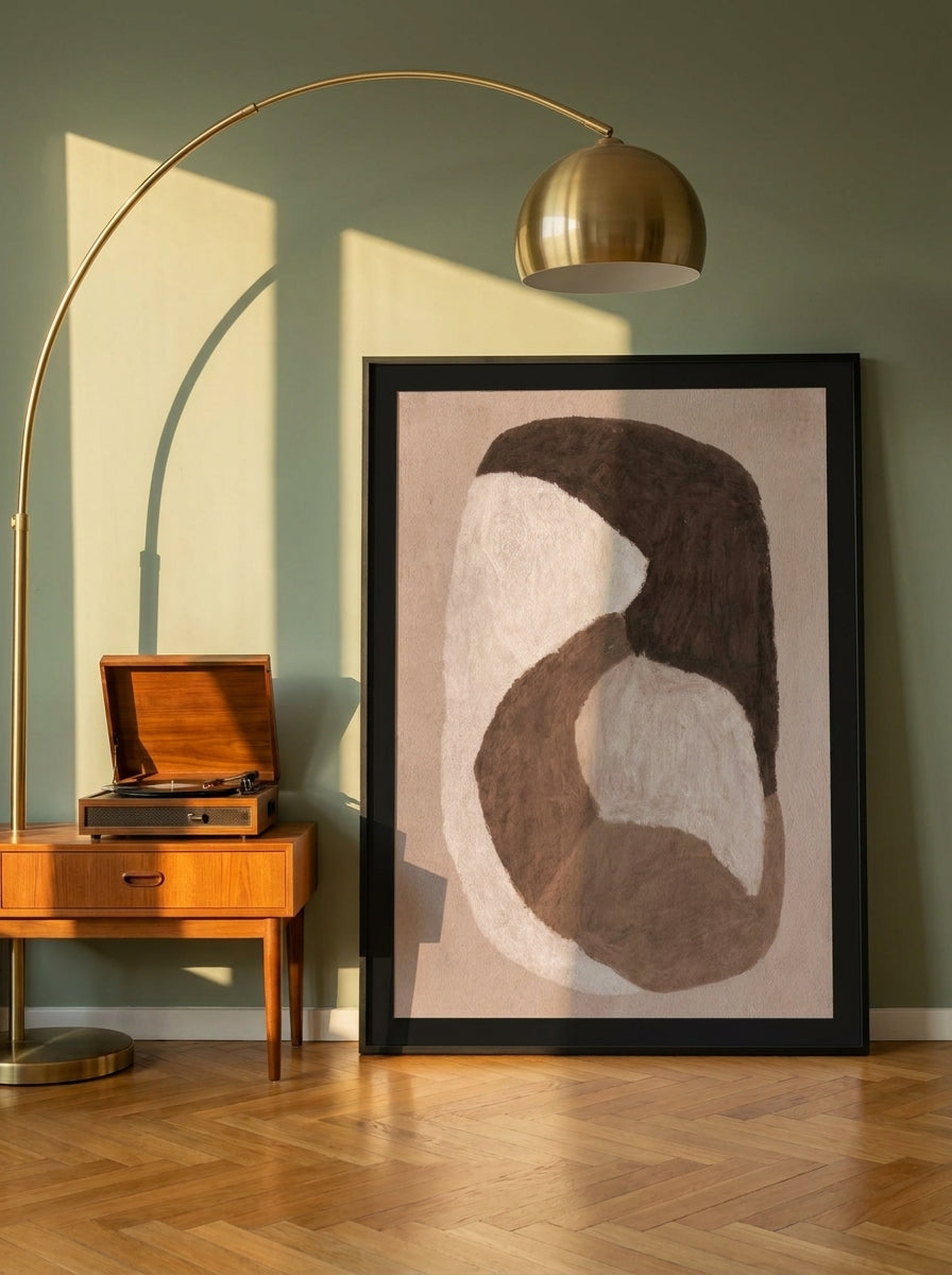 Oversized statement modern wall art print leaning against the wall in a mid-century home office