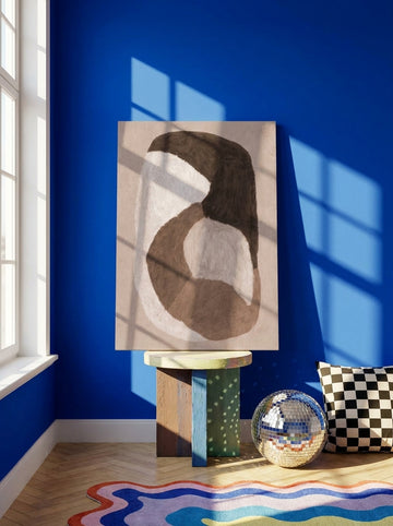 Stretched canvas wall art standing on a side table in a colourful eclectic bedroom