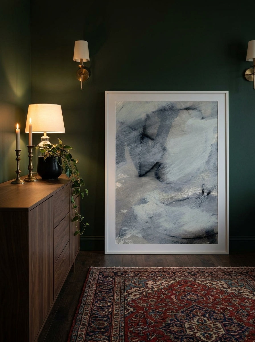 Modern wall art print standing on a sideboard in a moody home office
