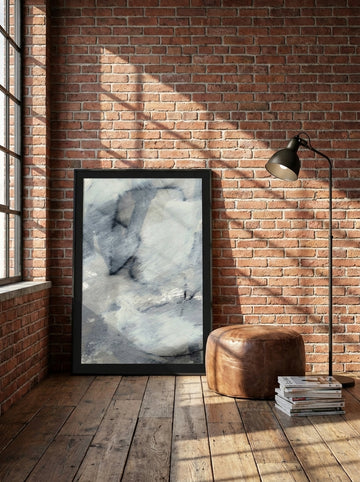 Modern wall art print leaning against the wall in an industrial loft living room