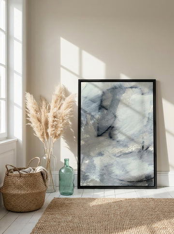 Canvas wall art with a black surround leaning against the wall in a coastal living room