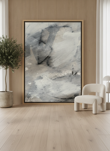 Oversized statement canvas wall art with a natural timber surround leaning against the wall in a luxe dining room