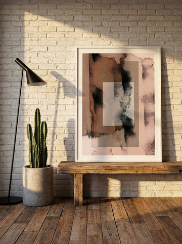 Modern wall art print standing on a bench in an industrial loft bedroom