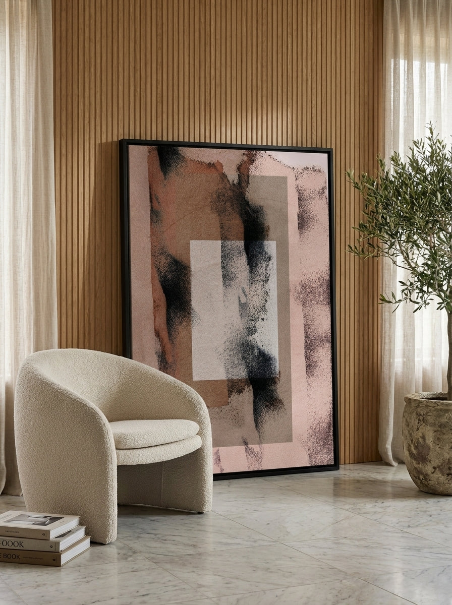 Oversized statement canvas wall art with a black surround leaning against the wall in a luxe living room