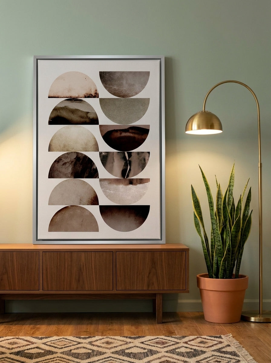 Canvas wall art with a silver leaf surround standing on a sideboard in a mid-century home office