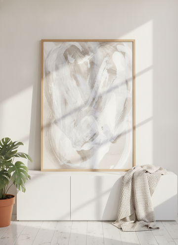 Modern wall art print standing on a sideboard in a bright Scandinavian home office