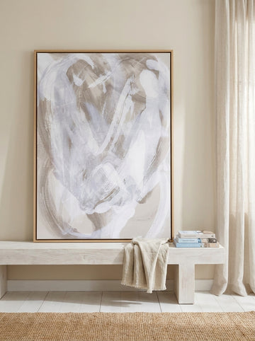 Canvas wall art with a natural timber surround standing on a console in a coastal home office