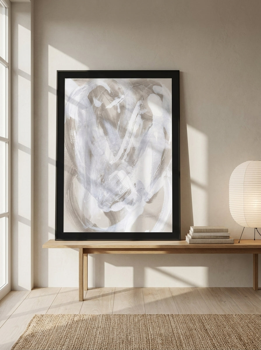 Modern wall art print standing on a bench in a warm Japandi bedroom