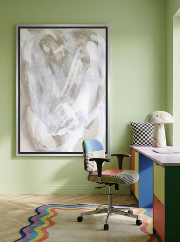 Canvas wall art with a silver leaf surround styled on the wall in a colourful eclectic home office