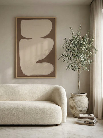 Oversized statement canvas wall art with a natural timber surround styled on the wall in a luxe living room