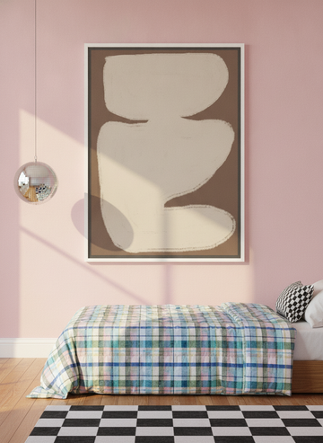 Canvas wall art with a white surround styled on the wall in a colourful eclectic bedroom