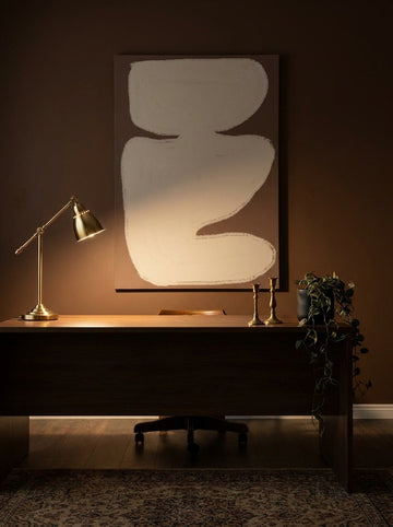 Stretched canvas wall art styled on the wall in a moody home office
