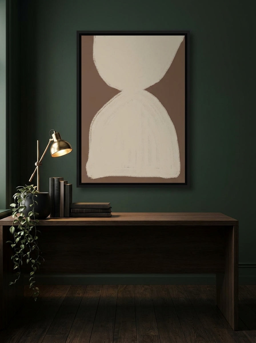 Canvas wall art with a black surround styled on the wall in a moody home office