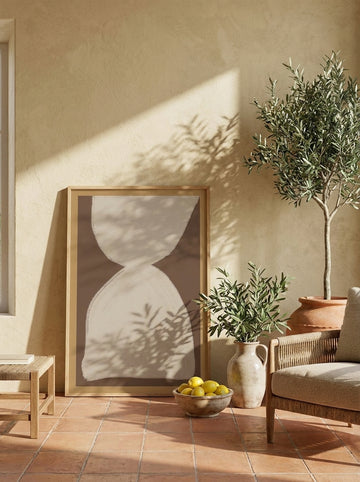 Oversized statement modern wall art print leaning against the wall in a Mediterranean living room