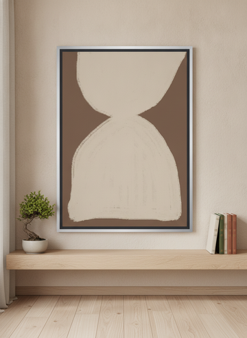 Canvas wall art with a silver leaf surround standing on a shelf in a warm Japandi home office