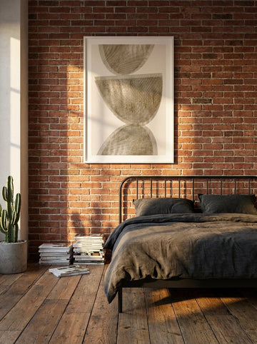 Modern wall art print styled on the wall in an industrial loft bedroom