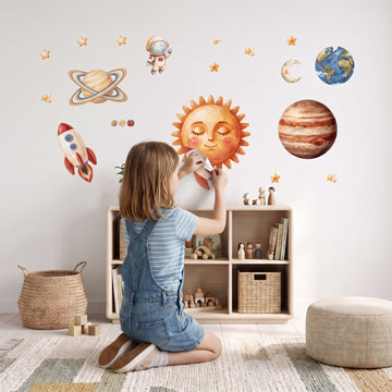 Storybook Solar System Wall Decal Set Wall Sticker Decals wall decals: a girl putting the decals up in a kids' room