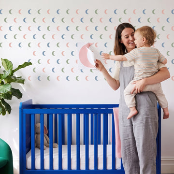 Crescent Moon Trio Wall Sticker Decals wall decals: a toddler and their mum putting the decals up in a nursery