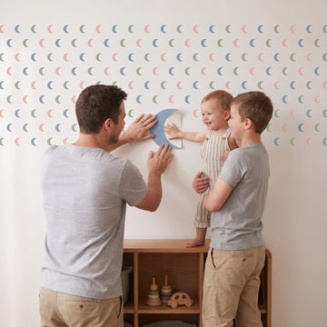 Crescent Moon Trio Wall Sticker Decals wall decals: a toddler and their dad putting the decals up in a kids' room