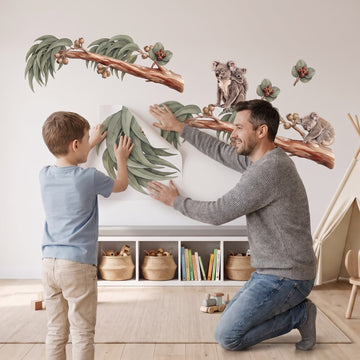 Koala and Gum Tree Wall Sticker Decals wall decals: a boy and his dad putting the decals up in a playroom