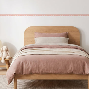 Scallop Border Panels Wall Sticker Decals running across a girl's bedroom wall (in Blush)