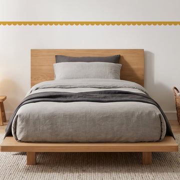 Scallop Border Panels Wall Sticker Decals running across a boy's bedroom wall (in Mustard)