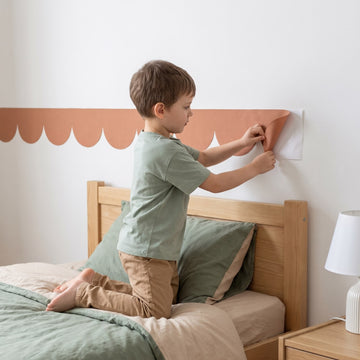 Scallop Border Panels Wall Sticker Decals wall decals: a boy putting the decals up in a boy's bedroom