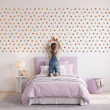 Pebble Dot Wall Sticker Decals wall decals: a girl putting the decals up in a girl's bedroom
